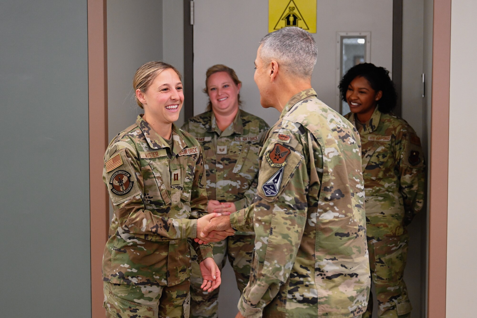 U.S. Air Force Lt. Gen. John J. DeGoes, U.S. Air Force Surgeon General, presents a challenge coin to Capt. Alexa Wister, 97th Healthcare Operations Squadron physician assistant, at Altus Air Force Base, Oklahoma, Aug. 26, 2024. DeGoes met multiple Airmen from the 97th Medical Group and awarded challenge coins. (U.S. Air Force photo by Airman 1st Class Jonah Bliss)