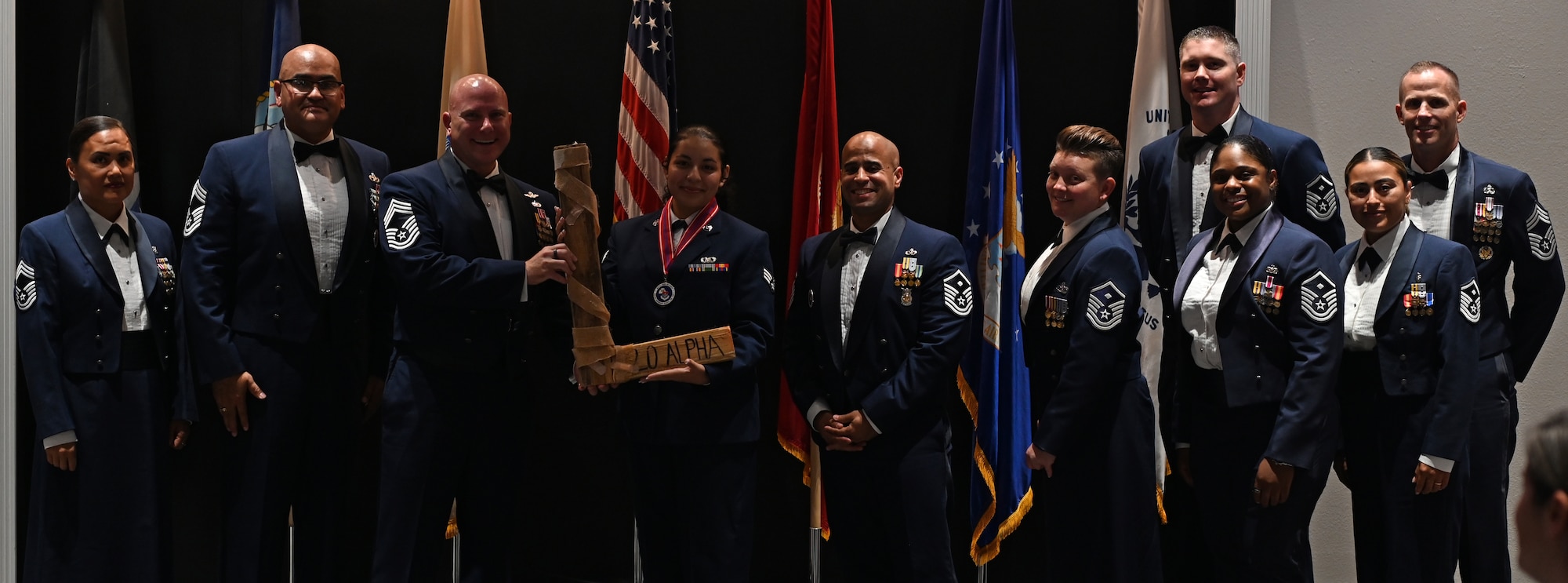U.S. Air Force Chief Master Sgt. Kenneth Wilson, 47th Operations Group senior enlisted leader, hands the “L” to Senior Airman Madison Salinas, Airman Leadership School graduate, at the Powell Event Center, Goodfellow Air Force Base, Texas, Sept. 5, 2024. Every ALS class plays a volleyball game with the first sergeants, and the winning team presents the “L” to the losing team. (U.S. Air Force photo by Senior Airman Ethan Sherwood)