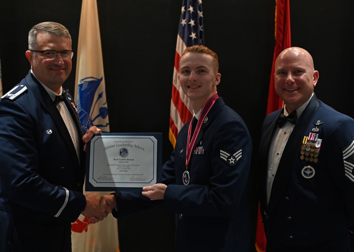 U.S. Air Force Senior Airman Caleb Strout, Airman Leadership School graduate, receives his diploma at the ALS class 24-F graduation at the Powell Event Center, Goodfellow Air Force Base, Texas, Sept. 5, 2024. ALS prepares Airmen over a 5-week course to become frontline supervisors. (U.S. Air Force photo by Senior Airman Ethan Sherwood)