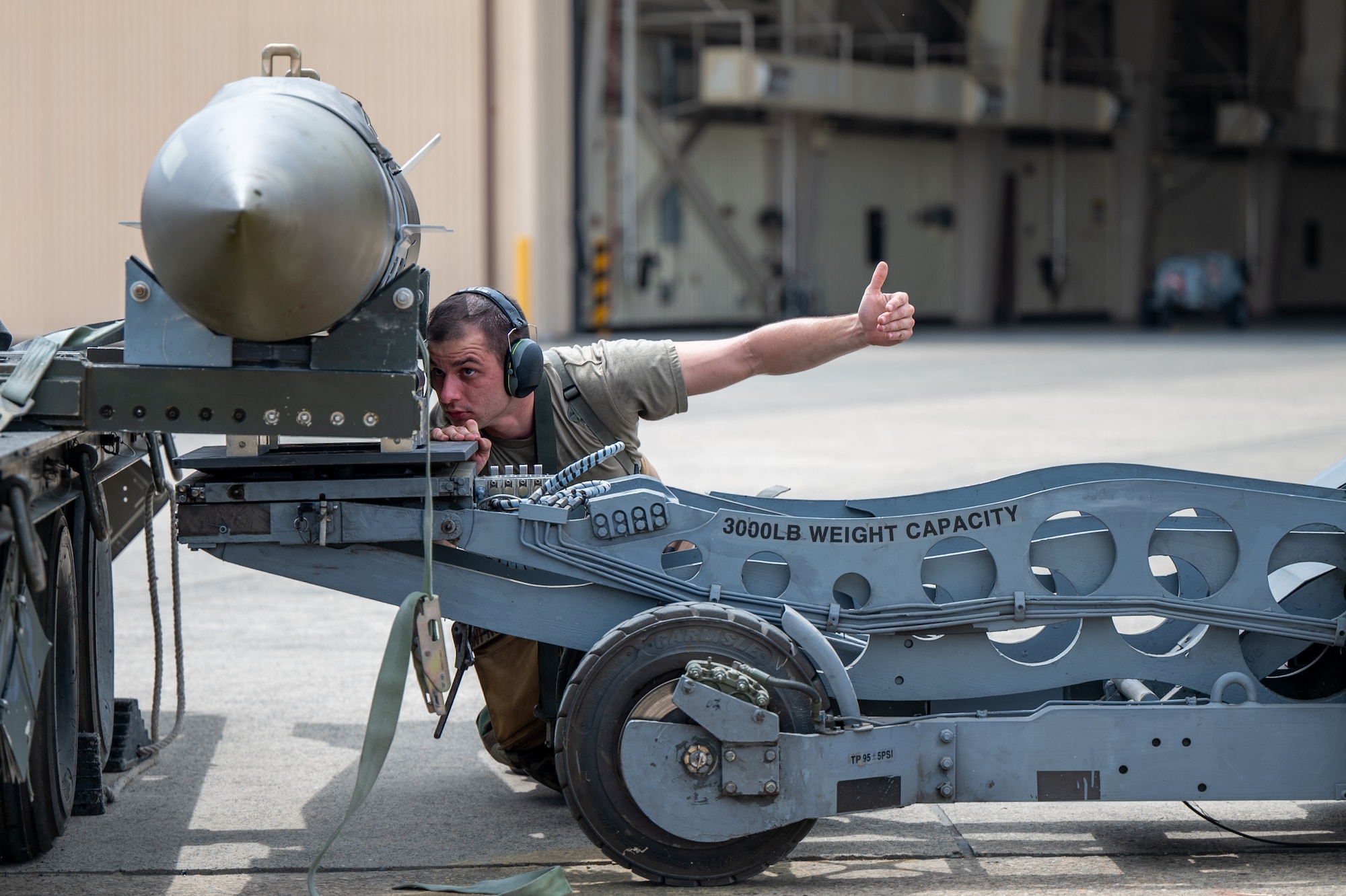 U.S. Air Force Staff Sgt. Jonathon Michelotii, 8th Fighter Generation Squadron weapons load team chief, prepares an inert GBU-31 armament for transport during Ulchi Freedom Shield 24 at an unspecified location in the Republic of Korea, Aug. 20, 2024. Regularly testing response capabilities is vital to maintaining a properly postured force that is prepared to deliver airpower in the U.S. Indo-Pacific Command area of responsibility at any time. UFS24, a defense-oriented exercise, focused on fortifying response capabilities to safeguard security on the peninsula. (U.S. Air Force photo by Senior Airman Brittany Russell)