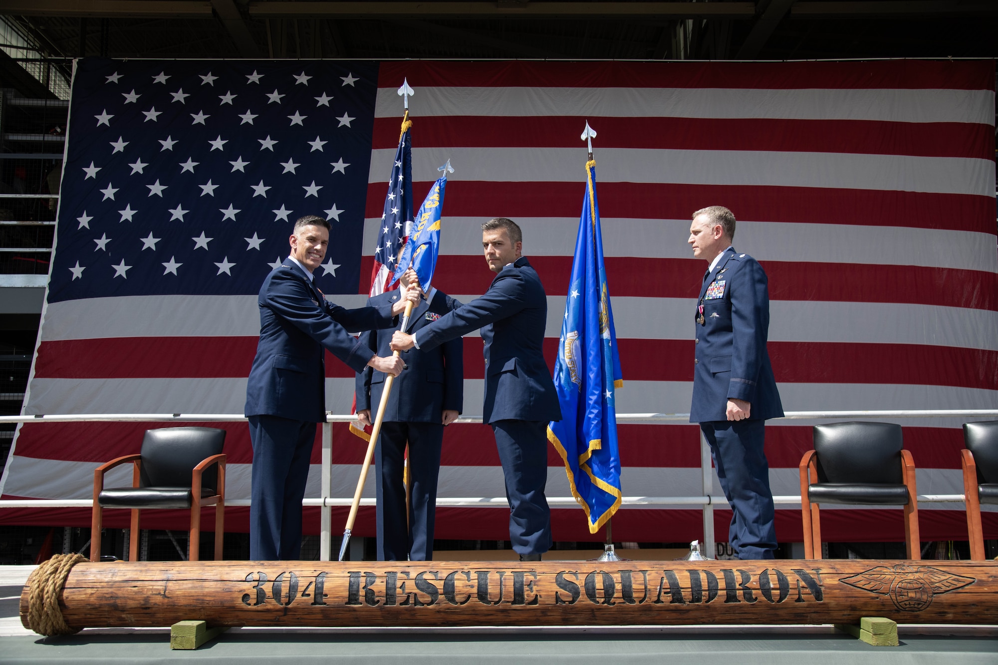 Col. Christopher Escajeda presents Lt. Col. Luc Chandu with the guidon.