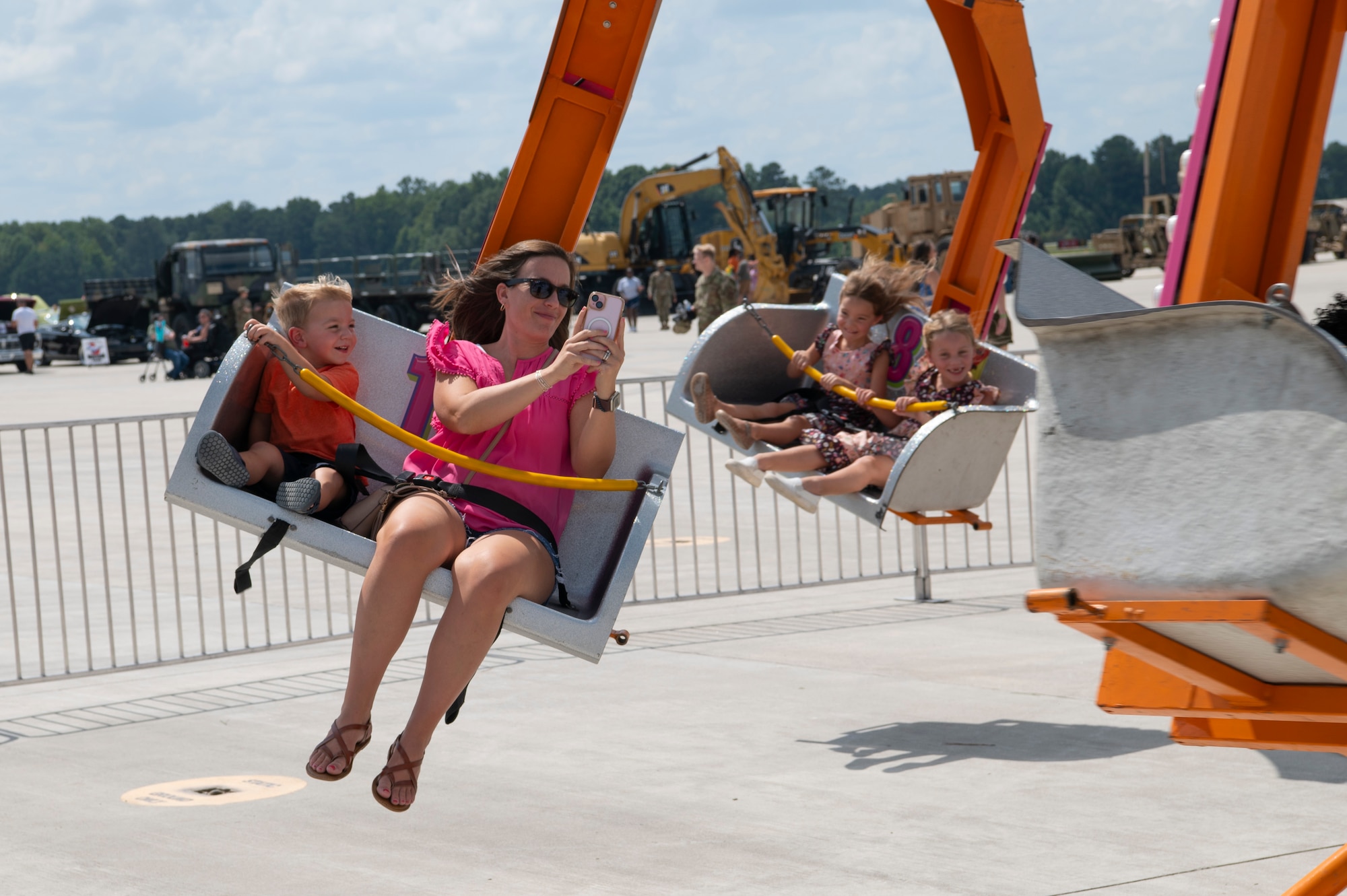 People ride a Ballistic Swing carnival ride.