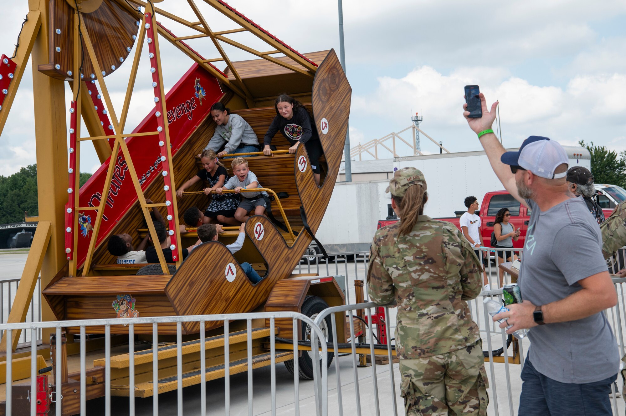 Children ride a swinging ship amusement park ride.