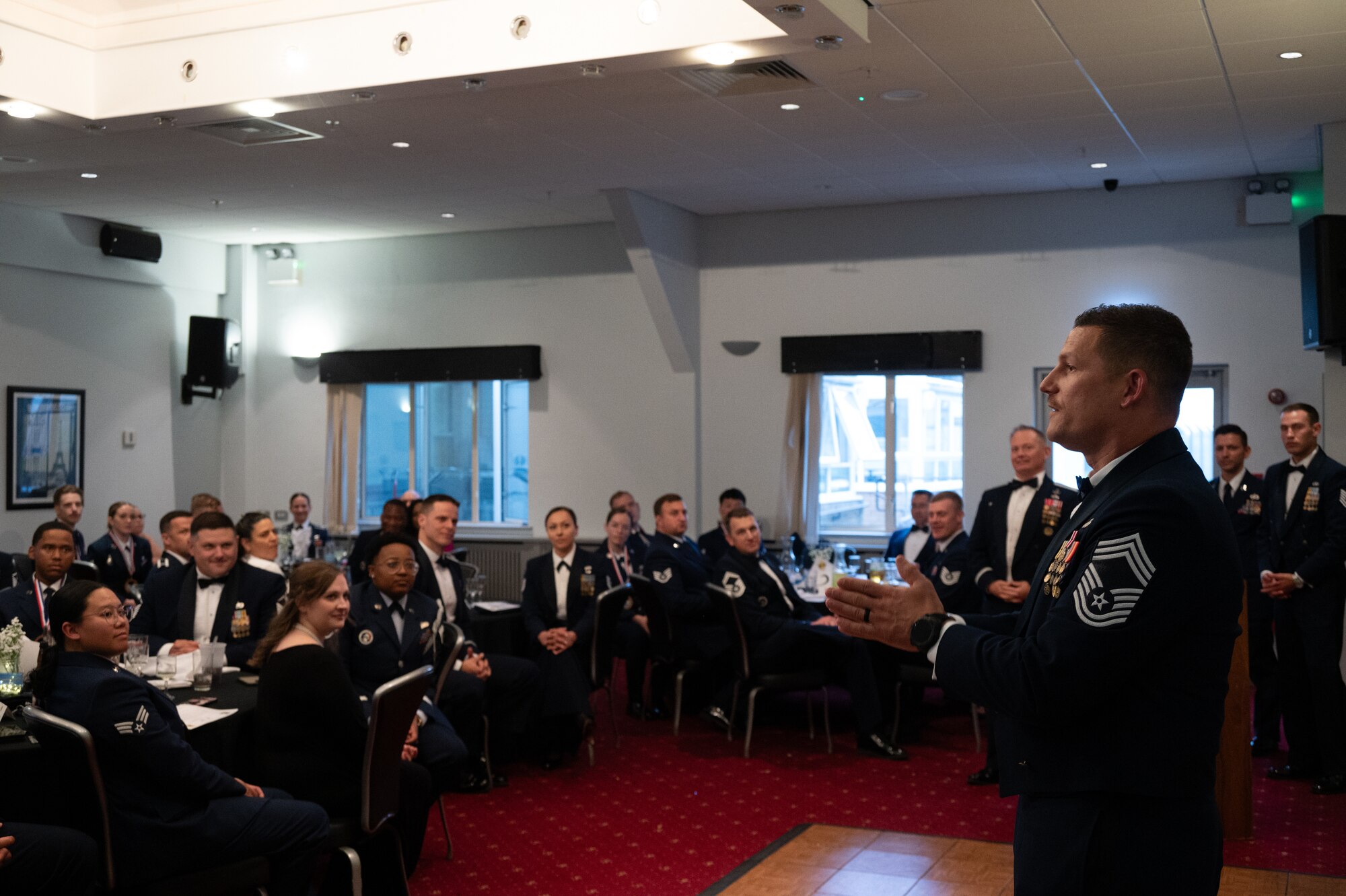 U.S. Air Force Chief Master Sgt. Nicholas Whitney, 422nd Air Base Group senior enlisted leader, gives a speech during a noncommissioned officer induction ceremony.