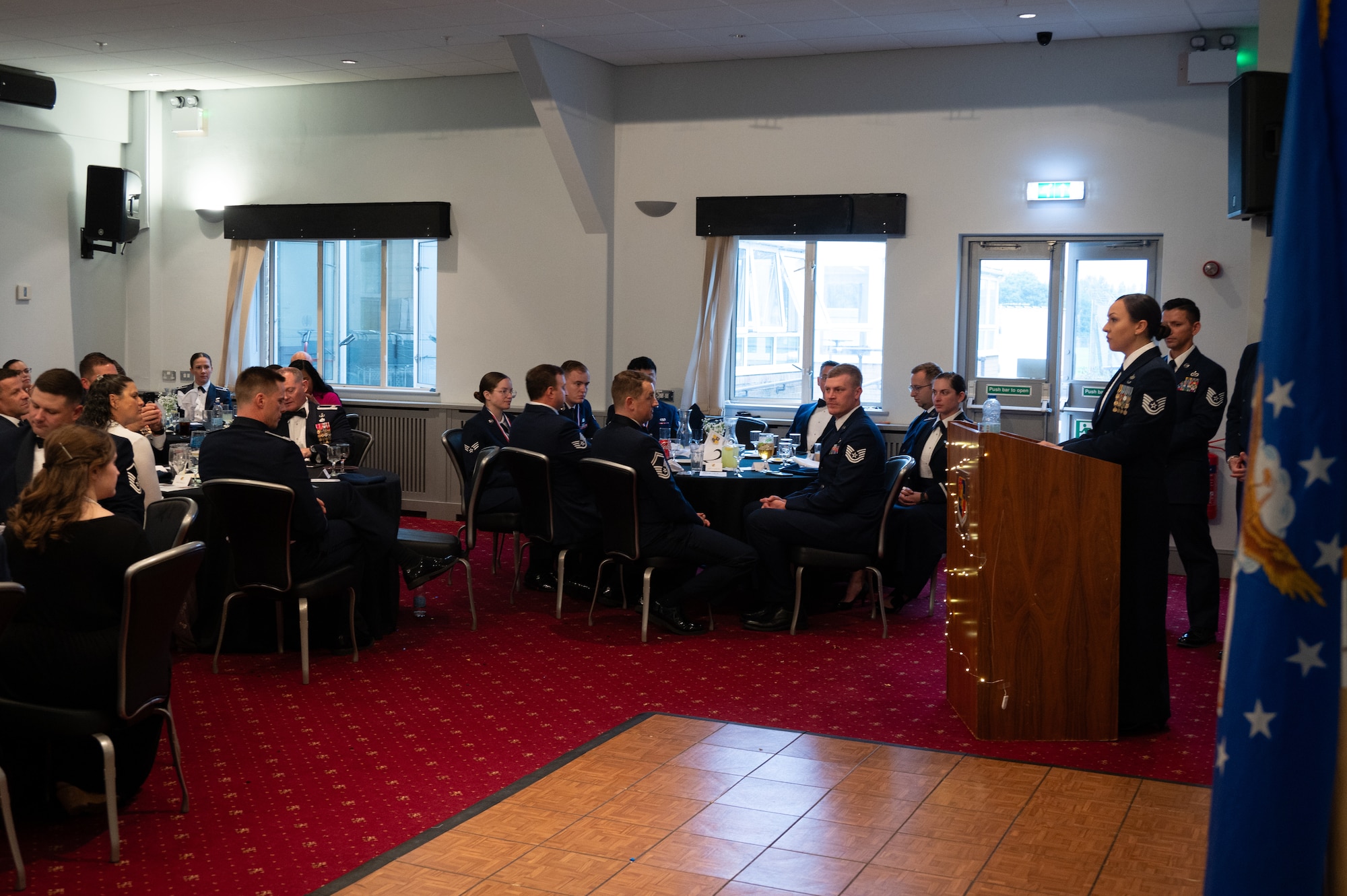 U.S. Air Force Technical Sgt. Kaleigh Kennard, executive assistant to the 501st Combat Support Wing command chief, gives a speech