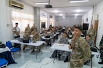 Hawaii Air National Guard Col. Glen Hayase, commander of the 154th Mission Support Group, briefs multinational participants of a cyber exercise Aug. 26, 2024, in Surabaya, Indonesia. The exercise was part of Super Garuda Shield 2024, an Indonesia-led exercise to increase military interoperability between allies and partners.