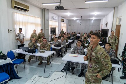 Hawaii Air National Guard Col. Glen Hayase, commander of the 154th Mission Support Group, briefs multinational participants of a cyber exercise Aug. 26, 2024, in Surabaya, Indonesia. The exercise was part of Super Garuda Shield 2024, an Indonesia-led exercise to increase military interoperability between allies and partners.