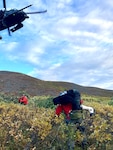 Alaska Air National Guard Maj. Dan Warren, right, 212th Rescue Squadron combat rescue officer, and Master Sgt. Harry Bromley, 212th RQS pararescueman, evacuate an injured airplane pilot Aug. 30, 2024, about 50 miles southwest of Tok to a 210th Rescue Squadron HH-60G Pave Hawk. Warren and Bromley jumped from a 211th Rescue Squadron HC-130J Combat King II to reach the injured pilot.
