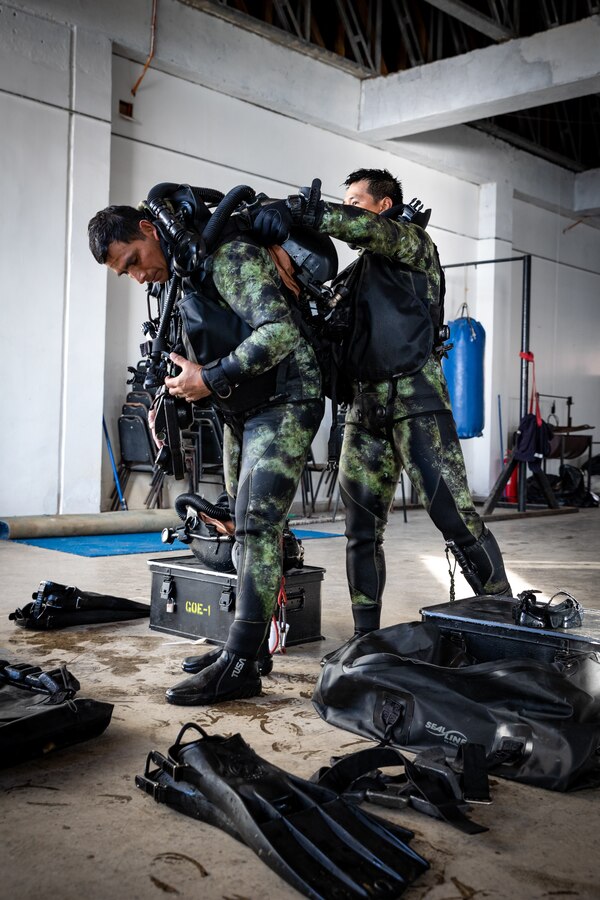 Peruvian naval special forces remove their gear after conducting dive operations during Exercise UNITAS LXV in Vina del Mar, Chile, Sept. 5, 2024. The dive operations consisted of several iterations of timed underwater navigation at 20 feet below sea level conducted at various distances. UNITAS focuses on strengthening our existing regional partnerships and encouraging the establishment of new relationships through the exchange of maritime mission-focused knowledge and expertise. (U.S. Marine Corps photo by Lance Cpl. Madisyn Paschal)