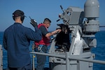 Gunner’s Mate 3rd Class Joshua Rivas, right, from Inglewood, Calif., and Aviation Ordnanceman 1st Class Erik Brown, from Cocoa Beach, Fla., prepare a MK 38 machine gun system for a live-fire exercise on the fantail of the Nimitz-class aircraft carrier USS Abraham Lincoln (CVN72). Abraham Lincoln is currently underway conducting routine operations in the 3rd Fleet area of responsibility.