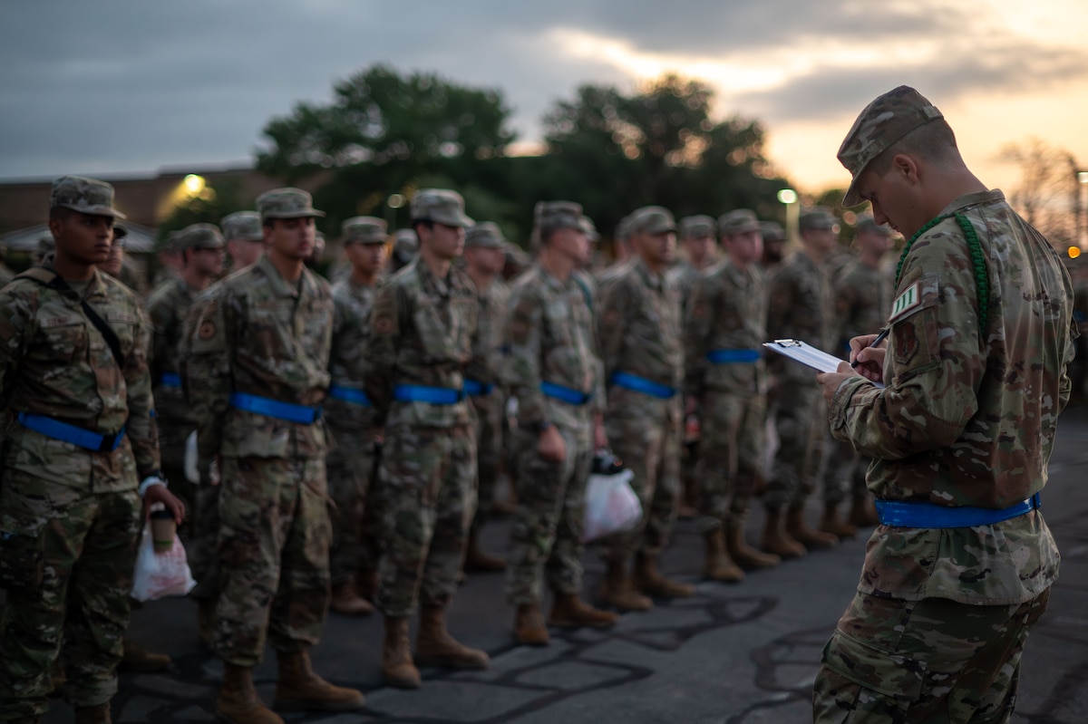 U.S. Air Force Airman student leader assigned to the 315th Training Squadron takes accountability during morning formation outside the Western Winds dining facility at Goodfellow Air Force Base, Texas, July 29, 2024. Green ropes are tasked with serving as an Airman Leader while providing peer-to-peer mentorship and assistance to other Airmen in training. (U.S. Air Force photo by Airman 1st Class Brian Lummus)
