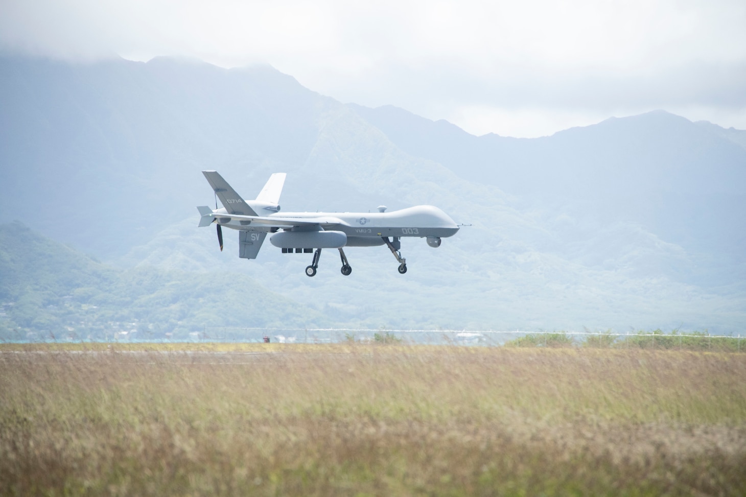 A U.S. Marine Corps MQ-9A MUX/MALE assigned to Marine Unmanned Aerial Vehicle Squadron (VMU) 3, Marine Aircraft Group 24, 1st Marine Aircraft Wing prepares to land onto the flightline after conducting drills during the first Satellite Communications (SATCOM) Launch and Recovery (SLR) mission at Marine Corps Air Station Kaneohe Bay, Hawaii, June 20. SLR minimizes logistical constraints, enables operations from short airfields over vast distances, and supports the flexibility required for modern expeditionary operations. VMU-3's successful SLR demonstration emphasized its pivotal role in advancing Marine Corps capabilities in reconnaissance, surveillance, and target acquisition missions across the Indo-Pacific region.