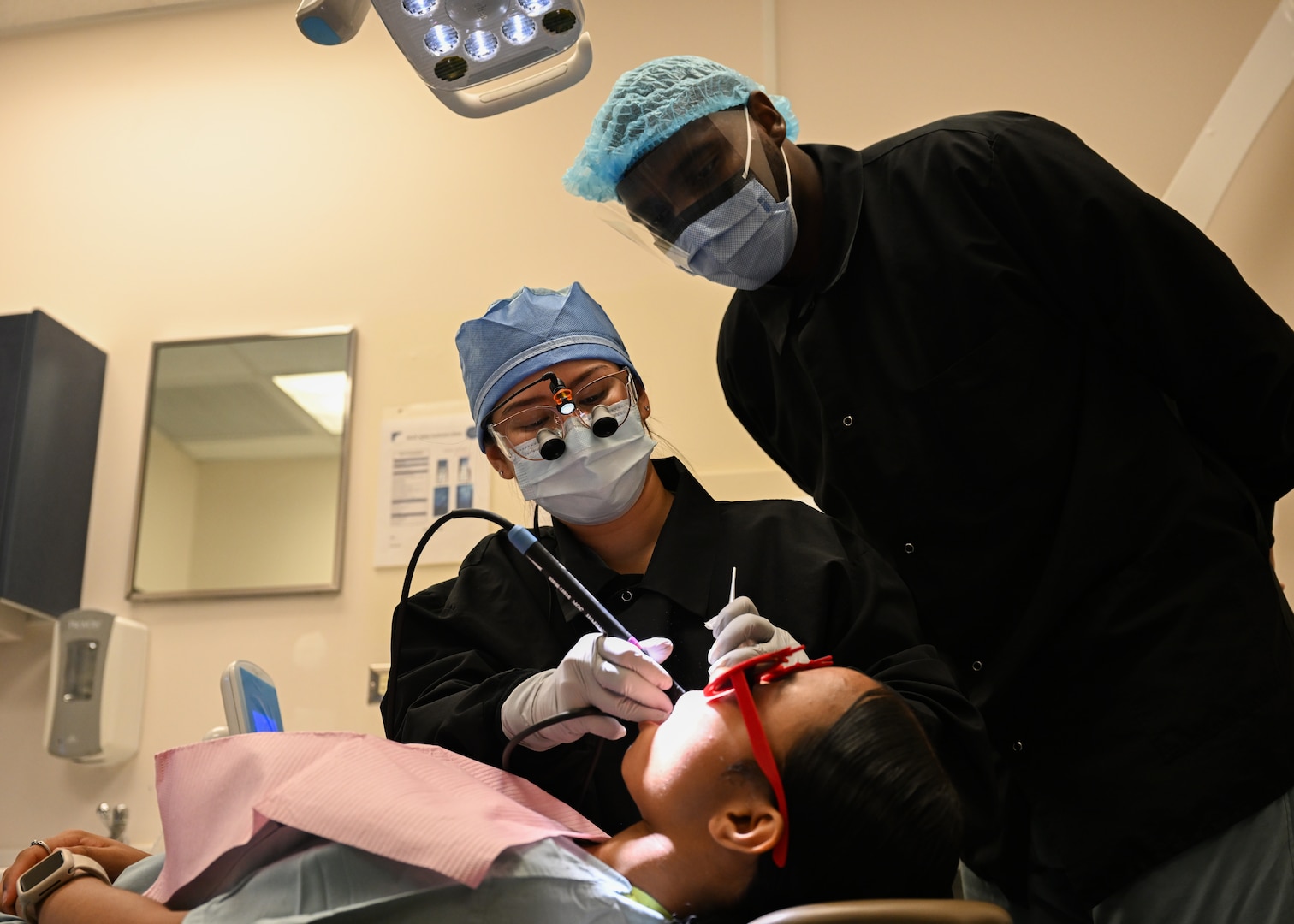 An instructor at the Air Force Oral Hygiene Course at Joint Base San Antonio-Lackland, Texas, demonstrates a dental procedure to a student at Dunn Dental Clinic on Joint Base San Antonio-Lackland, Texas Aug 28, 2024.