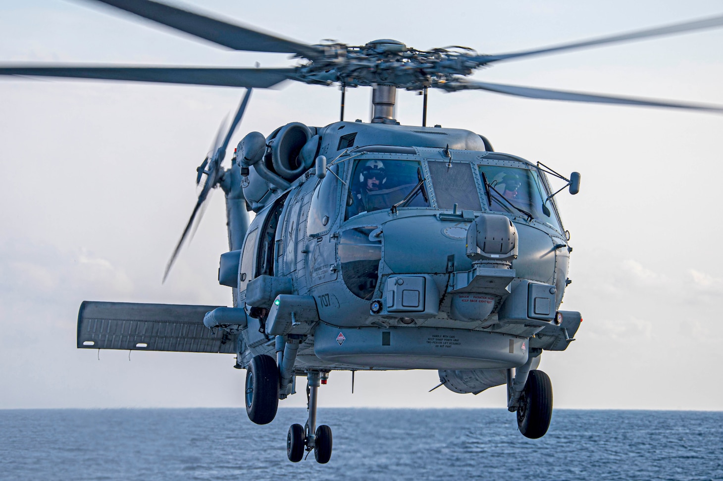 An MH-60R helicopter attached to the “Spartans” of Helicopter Maritime Strike Squadron (HSM) 70, embarked on the USS Gerald R. Ford (CVN 78), hoovers over the fantail of the guided-missile destroyer USS Arleigh Burke (DDG 51) Sept. 5, 2020, during Deck Landing Qualifications. Burke is underway in the Atlantic Ocean conducting basic phase training evolutions.