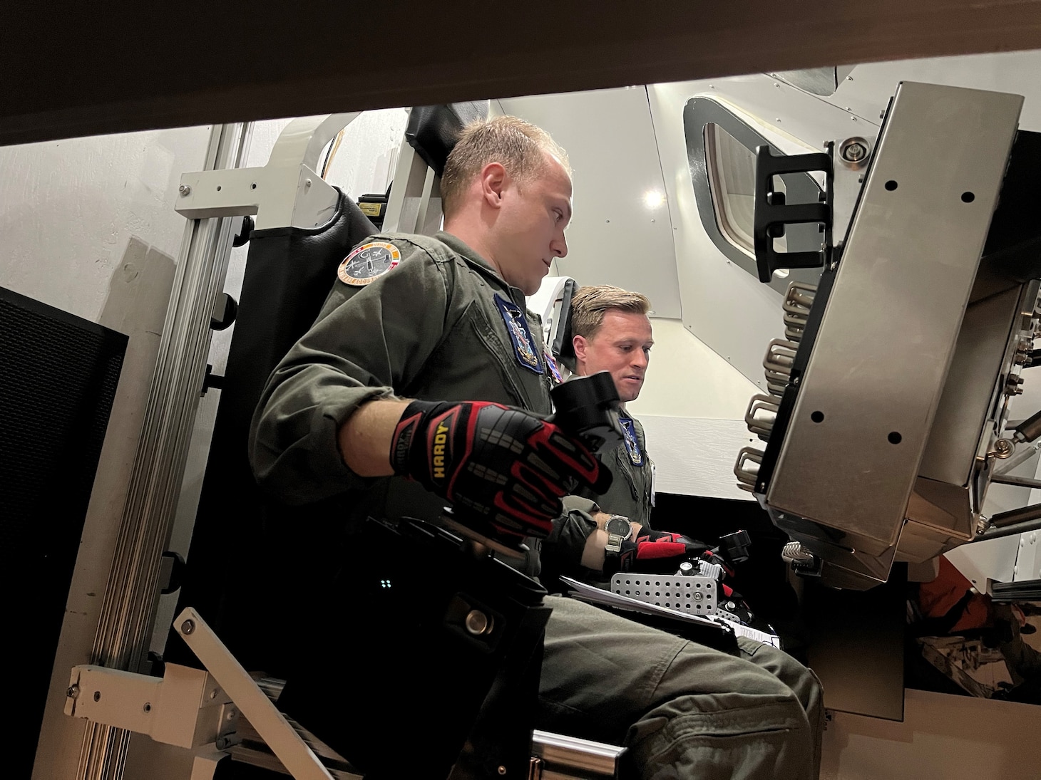 U.S. Naval Test Pilot School students Michael James and Lt. Cole VonDerOhe perform a simulated hand-flown, manual re-entry into the Earth’s atmosphere after a return trajectory from the moon during a recent technical exchange with NASA’s Johnson Space Center in Houston, Texas.