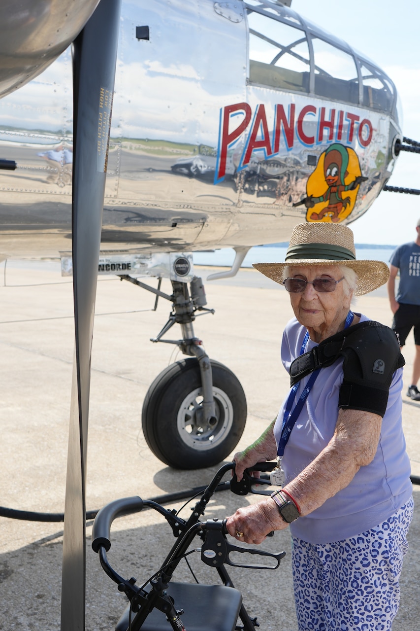 Betty Jean Holly, a real-life Rosie Riveter, poses with a World War II era B-25 bomber on the flight line at the U.S. Naval Test Pilot School in Patuxent River, Maryland on June 4, 2024. Holly, who celebrates her 99th birthday two days after the 80th anniversary of D-Day, drilled holes and installed rivets onboard the warplanes in 1943 on a factory production line. During the visit, she fondly recalled the factory job that gave her both independence and an opportunity to show her patriotism when many of the young men from her town were drafted. Test pilots under instruction at the school fly the B-25 bomber during training to learn evaluation of different flight characteristics.