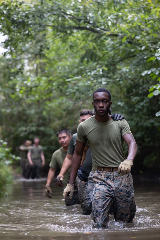 U.S. Marine Corps Sgt. Dylan Pemberton, transmission system operator, and other Marines assigned to 4th Assault Amphibian Battalion, wade through water during an obstacle course at Berga Naval Base, Sweden, Aug. 30, 2024. Marines assigned to 4th Assault Amphibian Battalion, 4th Marine Division, Marine Forces Reserve, are deployed for training in support of Exercise Archipelago Endeavor, an annual integrated, Swedish Armed Forces-led exercise that increases operational capabilities between U.S. Marines and Swedish forces. (U.S. Marine Corps photo by Sgt. Scott Jenkins)