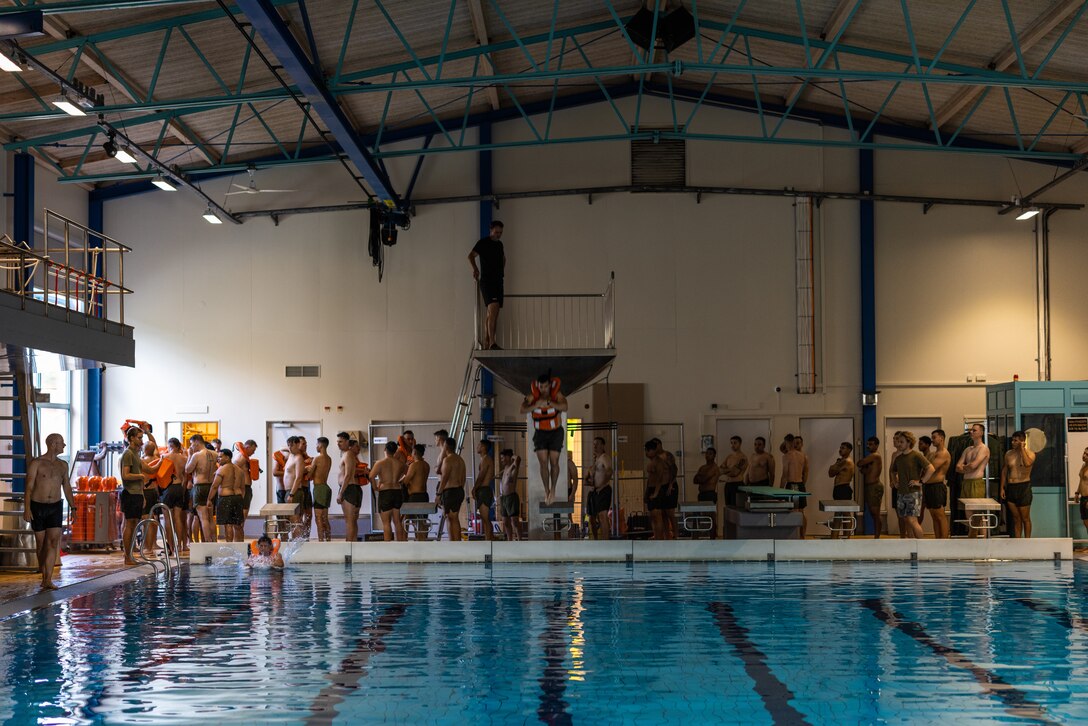 U.S. Marines assigned to 4th Assault Amphibian Battalion climb out of a pool during a basic swimming ability test at Berga Naval Base, Sweden, Aug. 27, 2024. The swim qualification covered basic swim skills, survival tactics and application of life vests and life rafts. Marines with 4th Assault Amphibian Battalion, 4th Marine Division, Marine Forces Reserve, are deployed for training in support of Exercise Archipelago Endeavor, an annual integrated, Swedish Armed Forces-led exercise that increases operational capabilities between U.S. Marines and Swedish forces. (U.S. Marine Corps photo by Sgt. Scott Jenkins)