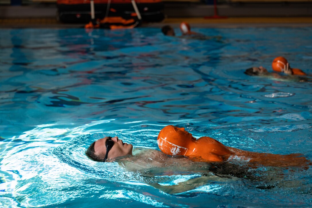 U.S. Marine Corps Sgt. Jonathan Ebel, assault amphibious vehicle technician, swims with a simulated causality during basic swimming ability test at Berga Naval Base, Sweden, Aug. 27, 2024. The swim qualification covered basic swim skills, survival tactics and application of life vests and life rafts. Marines assigned to 4th Assault Amphibian Battalion, 4th Marine Division, Marine Forces Reserve, are deployed for training in support of Exercise Archipelago Endeavor, an annual integrated, Swedish Armed Forces-led exercise that increases operational capabilities between U.S. Marines and Swedish forces. (U.S. Marine Corps photo by Sgt. Scott Jenkins)