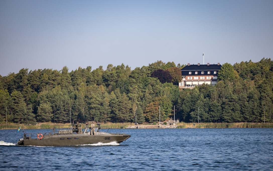 A CB90 combat boat, crewed by U.S. Marines and Swedish service members, transits through the Stockholm Archipelago at Berga Naval Base, Sweden, Aug. 29, 2024. Marines assigned to 4th Assault Amphibian Battalion, 4th Marine Division, Marine Forces Reserve, are deployed for training in support of Exercise Archipelago Endeavor, an annual integrated, Swedish Armed Forces-led exercise that increases operational capabilities between U.S. Marines and Swedish forces. (U.S. Marine Corps photo by Sgt. Scott Jenkins)
