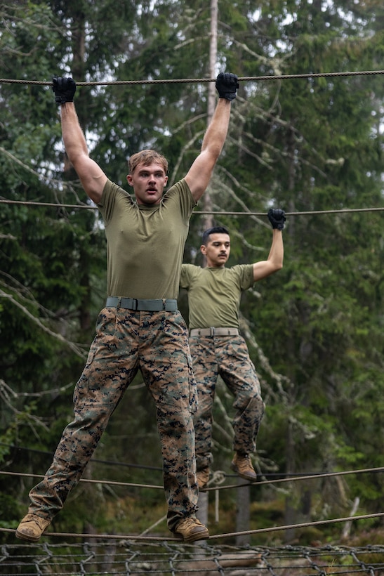 U.S. Marine Corps Cpl. Tyler New, assault amphibious vehicle technician, navigates a rope bridge during an obstacle course at Berga Naval Base, Sweden, Aug. 30, 2024. Marines assigned to 4th Assault Amphibian Battalion, 4th Marine Division, Marine Forces Reserve, are deployed for training in support of Exercise Archipelago Endeavor, an annual integrated, Swedish Armed Forces-led exercise that increases operational capabilities between U.S. Marines and Swedish forces. (U.S. Marine Corps photo by Sgt. Scott Jenkins)