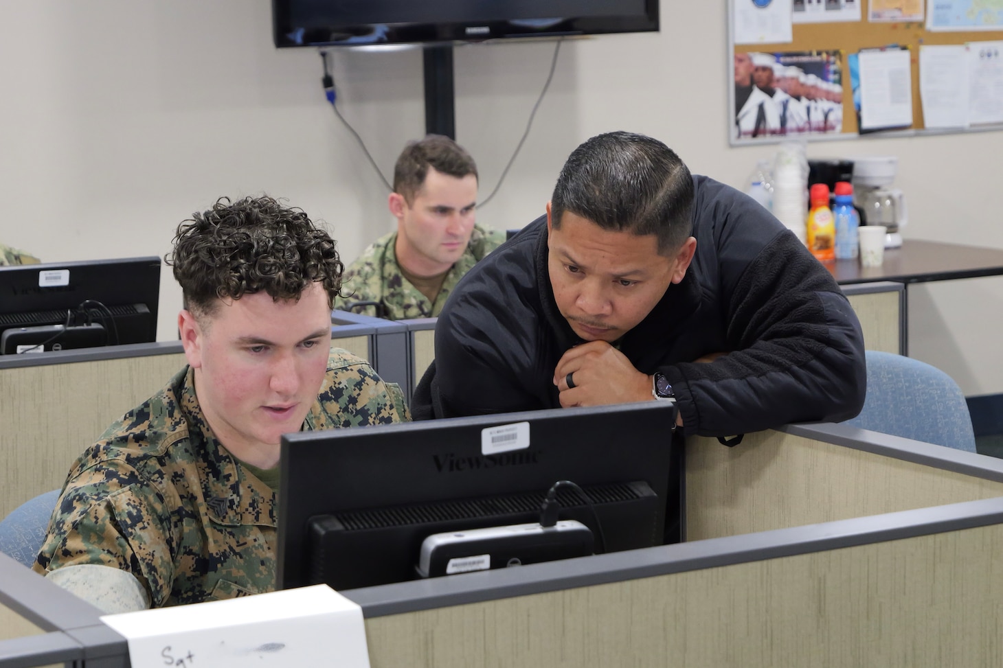 Sgt. Skylier Thompson, left, and CWO2 Mark Noble, right, work on a group project together in the JASMMM course.