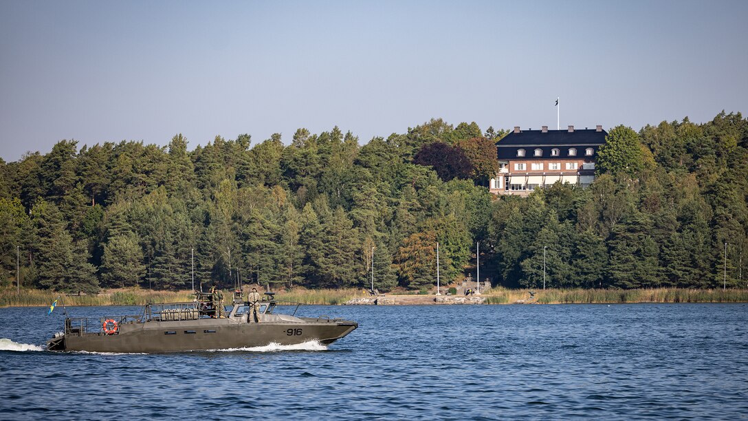 A CB90 combat boat, crewed by U.S. Marines and Swedish service members, transits through the Stockholm Archipelago at Berga Naval Base, Sweden, Aug. 29, 2024. Marines assigned to 4th Assault Amphibian Battalion, 4th Marine Division, Marine Forces Reserve, are deployed for training in support of Exercise Archipelago Endeavor, an annual integrated, Swedish Armed Forces-led exercise that increases operational capabilities between U.S. Marines and Swedish forces. (U.S. Marine Corps photo by Sgt. Scott Jenkins)
