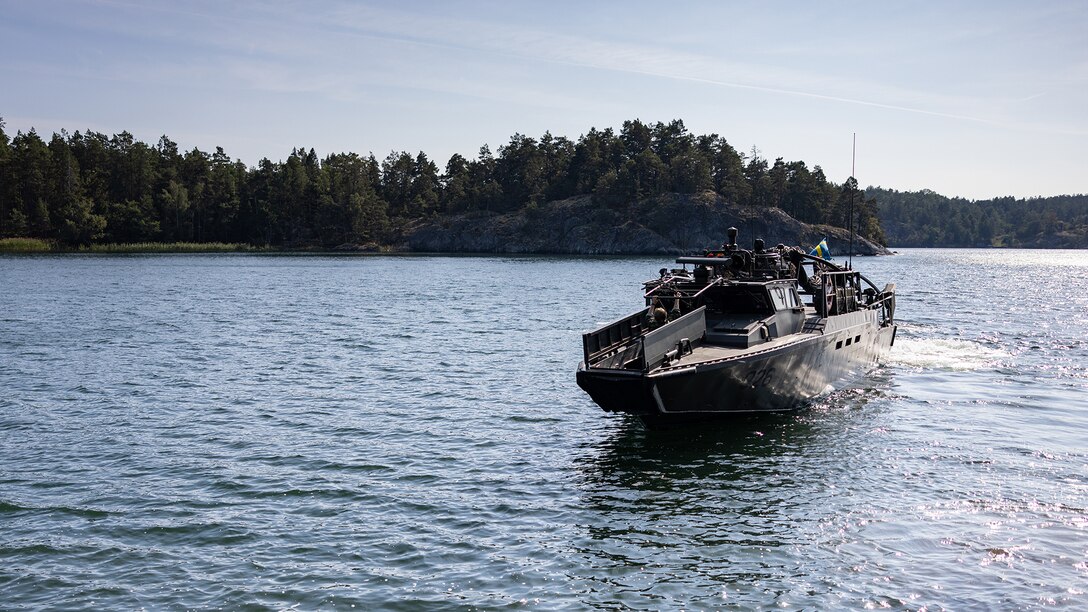 Swedish service members bring a CB90 combat boat to shore during a CB90 evasive maneuver familiarization course at Berga Naval Base, Sweden, Aug. 28, 2024. Marines assigned to 4th Assault Amphibian Battalion, 4th Marine Division, Marine Forces Reserve, are deployed for training in support of Exercise Archipelago Endeavor, an annual integrated, Swedish Armed Forces-led exercise that increases operational capabilities between U.S. Marines and Swedish forces. (U.S. Marine Corps photo by Sgt. Scott Jenkins)