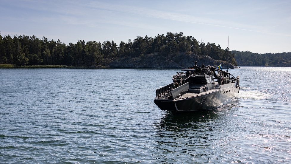 Swedish service members bring a CB90 combat boat to shore during a CB90 evasive maneuver familiarization course at Berga Naval Base, Sweden, Aug. 28, 2024. Marines assigned to 4th Assault Amphibian Battalion, 4th Marine Division, Marine Forces Reserve, are deployed for training in support of Exercise Archipelago Endeavor, an annual integrated, Swedish Armed Forces-led exercise that increases operational capabilities between U.S. Marines and Swedish forces. (U.S. Marine Corps photo by Sgt. Scott Jenkins)