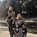 Family portrait of father, mother, and three daughters wearing Raiders gear