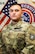 U.S. Army Soldier in uniform poses in front of American Flag and USAREC Flag for official headshot