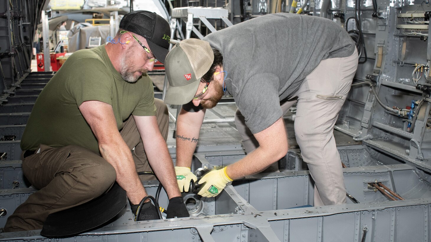 Fleet Readiness Center East (FRCE) aircraft mechanics Brian Hagopian, left, and Jonathan McAlonan, right, perform maintenance on a CH-53E Super Stallion at the depot. FRCE recently received the 2023 Chief of Naval Operations Shore Safety Award in the Large Industrial Activity category for the third time due to its commitment to safety and occupational health excellence. The depot’s safety culture, which strictly enforces the use of proper personal protective equipment, was a contributing factor to the win.