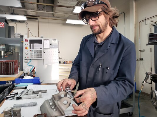 Matthew Wasner, a materials laboratory engineering technician at Fleet Readiness Center Southwest, undertakes one of his various responsibilities in the machine shop.