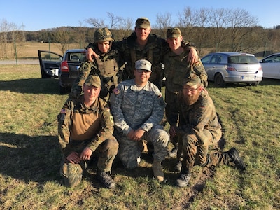 U.S. Army Soldiers pose together out in the field.