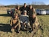 U.S. Army Soldiers pose together out in the field.