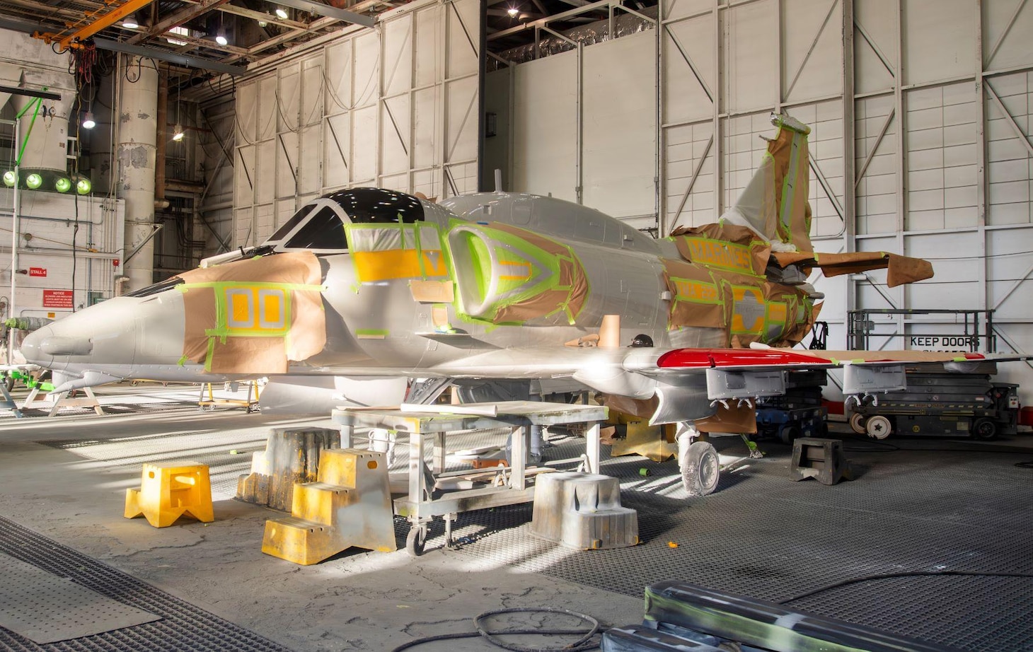 Fleet Readiness Center East (FRCE) Aircraft Paint Shop artisans apply stencils to the retired Douglas A-4M Skyhawk to ensure the placement and quality of the aircraft’s major markings and insignia. FRCE Artisans worked with local historians to design a historically accurate paint scheme.