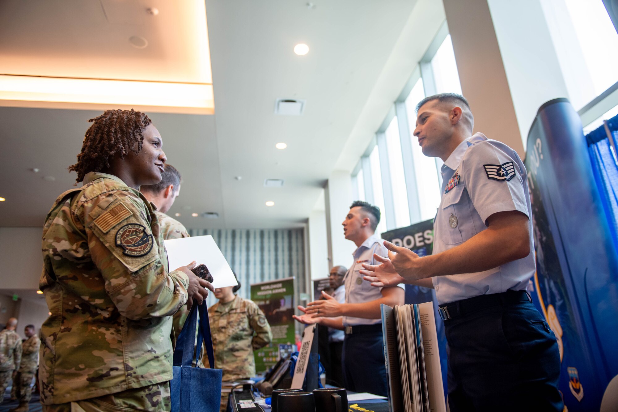 U.S. Air Force Airman 1st Class Shanelle King, Dover Air Force Base Honor Guard, speaks with U.S. Air Force Honor Guard Airmen during the 2024 Air Force Sergeants Association Summit at Houston, Texas, Aug. 13, 2024. The 2024 AFSA Summit is an international convention and professional development symposium. Attendees received professional education and development learning opportunities from senior leaders around the U.S. military. (U.S. Air Force photo by Tech. Sgt. J.D. Strong II)