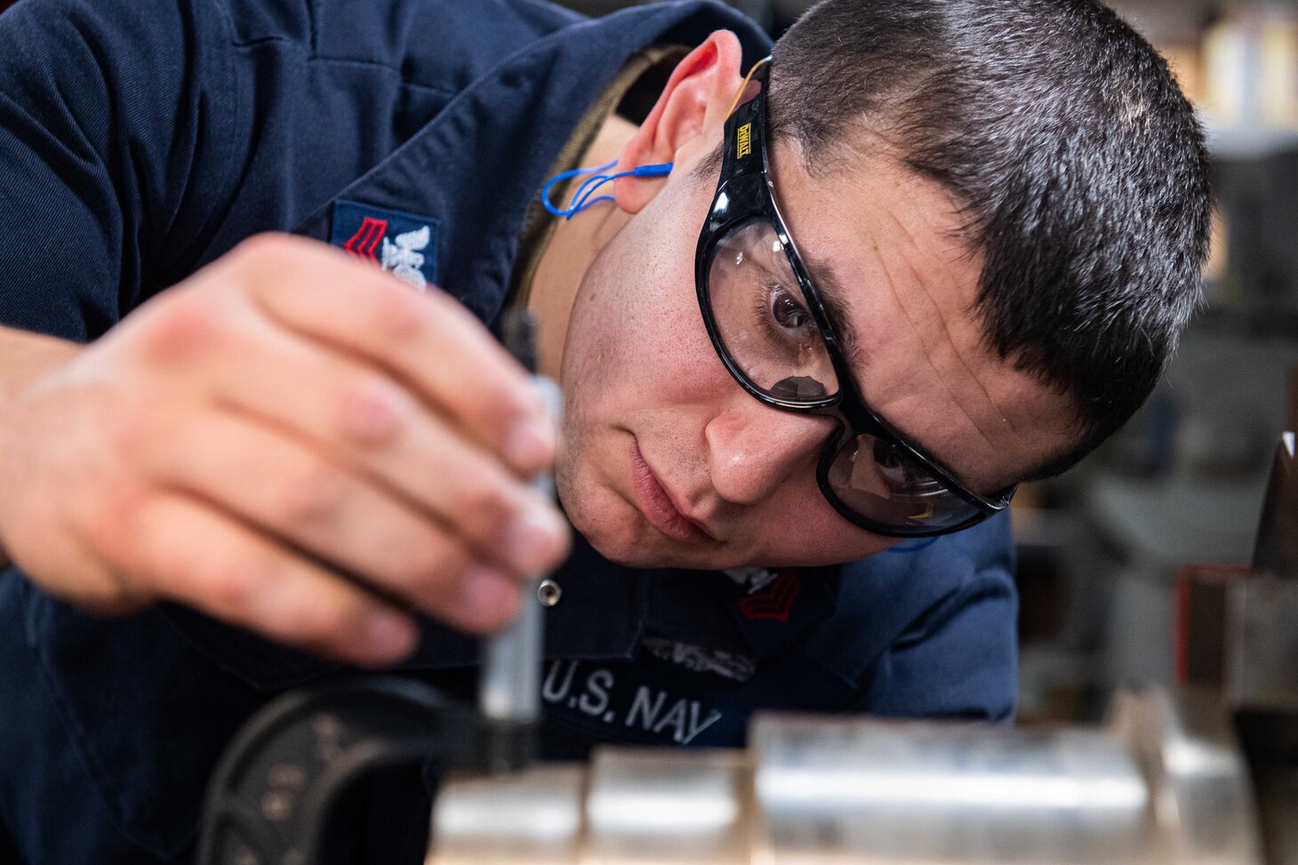 240604-N-ER894-1073 PHILIPPINE SEA (June 4, 2024) Machinery Repairman 1st Class Adam Lachman, from East Meadow, New York, uses a micrometer to measure a piece of steel before operating a lathe in the machine repair shop aboard the U.S. Navy’s only forward-deployed aircraft carrier, USS Ronald Reagan (CVN 76), in the Philippine Sea, June 4. Ronald Reagan, the flagship of Carrier Strike Group 5, provides a combat-ready force that protects and defends the United States, and supports alliances, partnerships and collective maritime interests in the Indo-Pacific region.