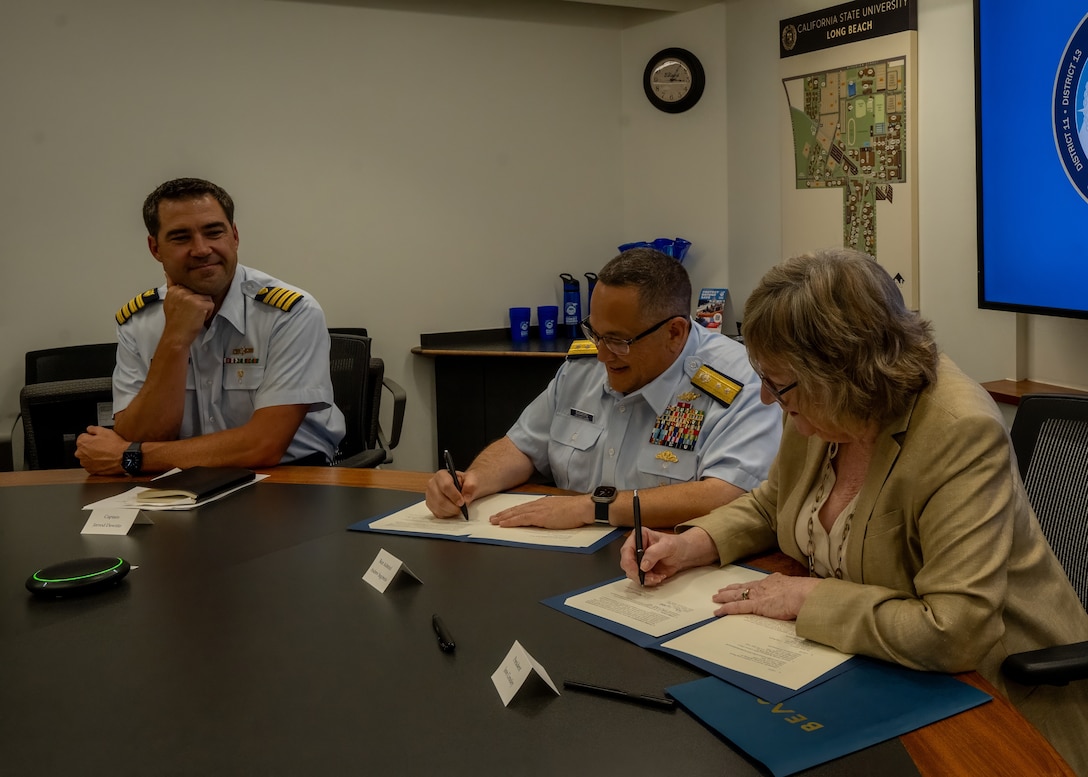 Rear Adm. Andrew Sugimoto, Coast Guard Pacific Area deputy commander, and Jane C. Conoley, California State University Long Beach (CSULB) president, sign a memorandum of understanding during a ceremony at CSULB campus in Long Beach, California, Sept. 5, 2024. The memorandum of understanding outlines the university as a member of the Coast Guard's Minority-Serving Institution partnership program. (U.S. Coast Guard photo by Petty Officer 1st Class Loumania Stewart)