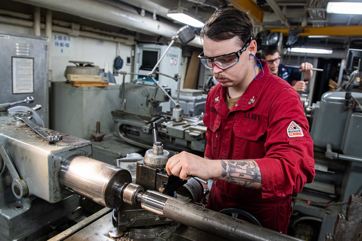 240604-N-ER894-1049 PHILIPPINE SEA (June 4, 2024) Machinery Repairman 2nd Class Kyle Martin, from Houston, operates a lathe to turn a piece of steel in the machine repair shop aboard the U.S. Navy’s only forward-deployed aircraft carrier, USS Ronald Reagan (CVN 76), in the Philippine Sea, June 4. Ronald Reagan, the flagship of Carrier Strike Group 5, provides a combat-ready force that protects and defends the United States, and supports alliances, partnerships and collective maritime interests in the Indo-Pacific region.