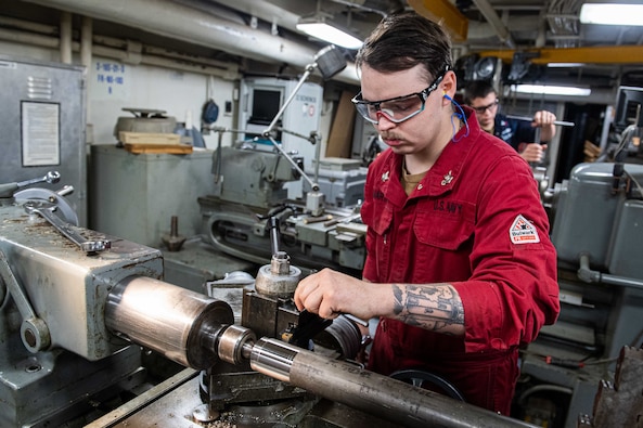 Machinery Repairman 1st Class Adam Lachman, repair division leading petty officer, from East Meadow, New York, and Machinery Repairman 2nd Class Kyle Martin, from Houston, led Ronald Reagan’s machine repair team in redesigning and fabricating a tool that helped to repair parts of the ship’s arresting gear wire system, May 30.