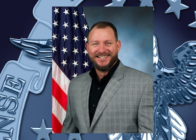 Portrait of man in suit with flag