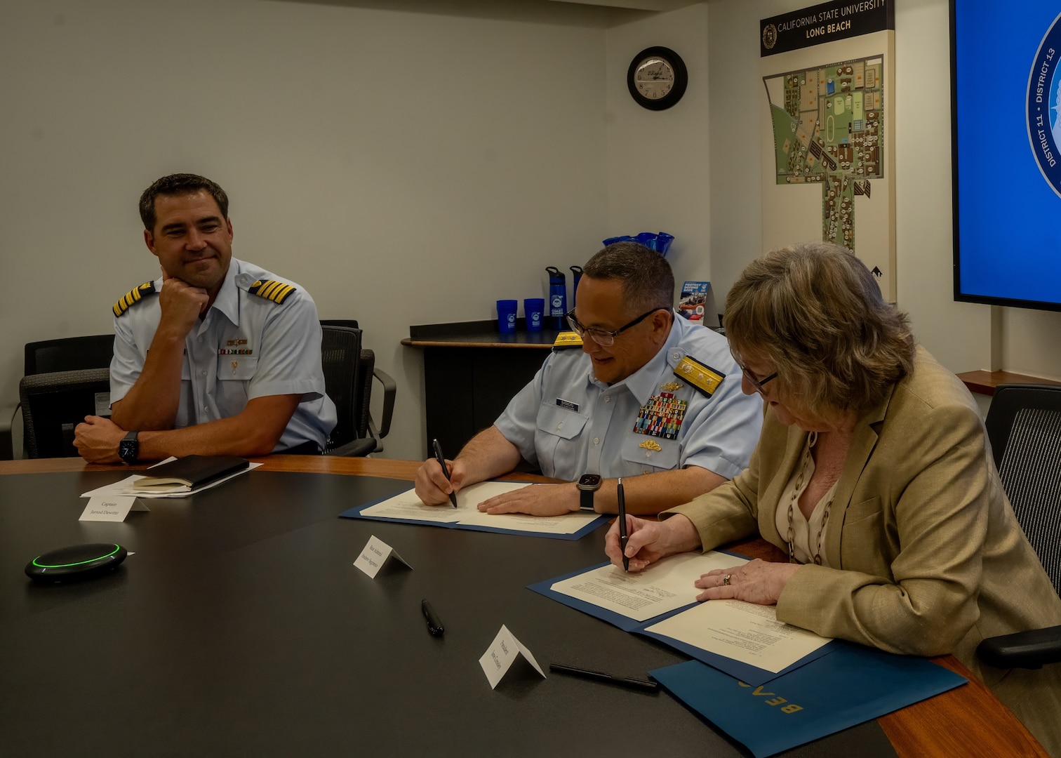 Rear Adm. Andrew Sugimoto, Coast Guard Pacific Area deputy commander, and Jane C. Conoley, California State University Long Beach (CSULB) president, sign a memorandum of agreement during a ceremony at CSULB campus in Long Beach, California, Sept. 5, 2024. The memorandum of agreement outlines the university as a member of the Coast Guard's Minority-Serving Institution partnership program. (U.S. Coast Guard photo by Petty Officer 1st Class Loumania Stewart)