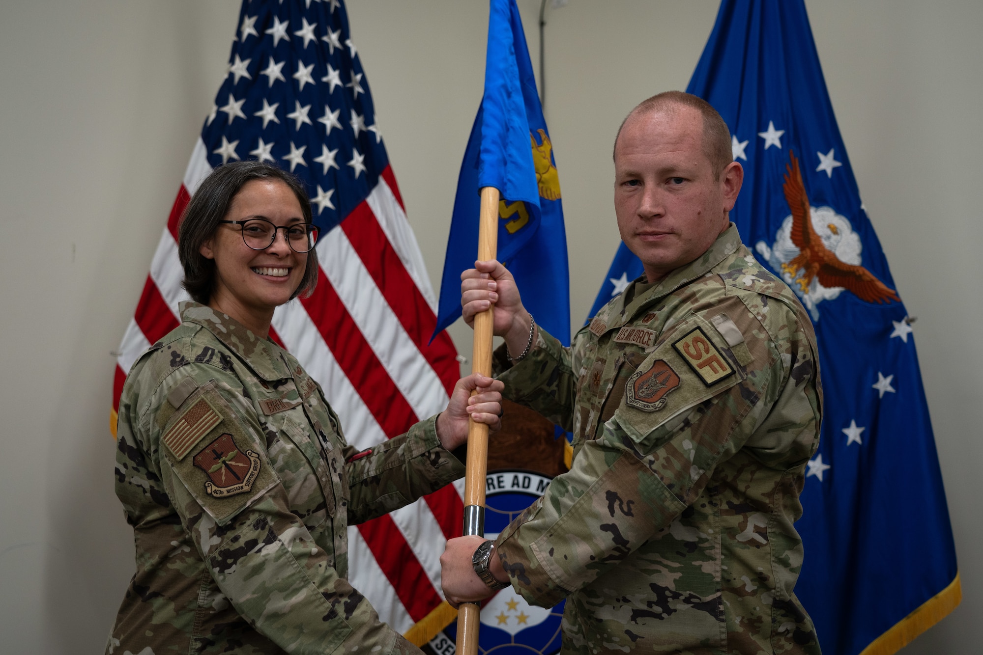 Breal hands a guidon to Glover