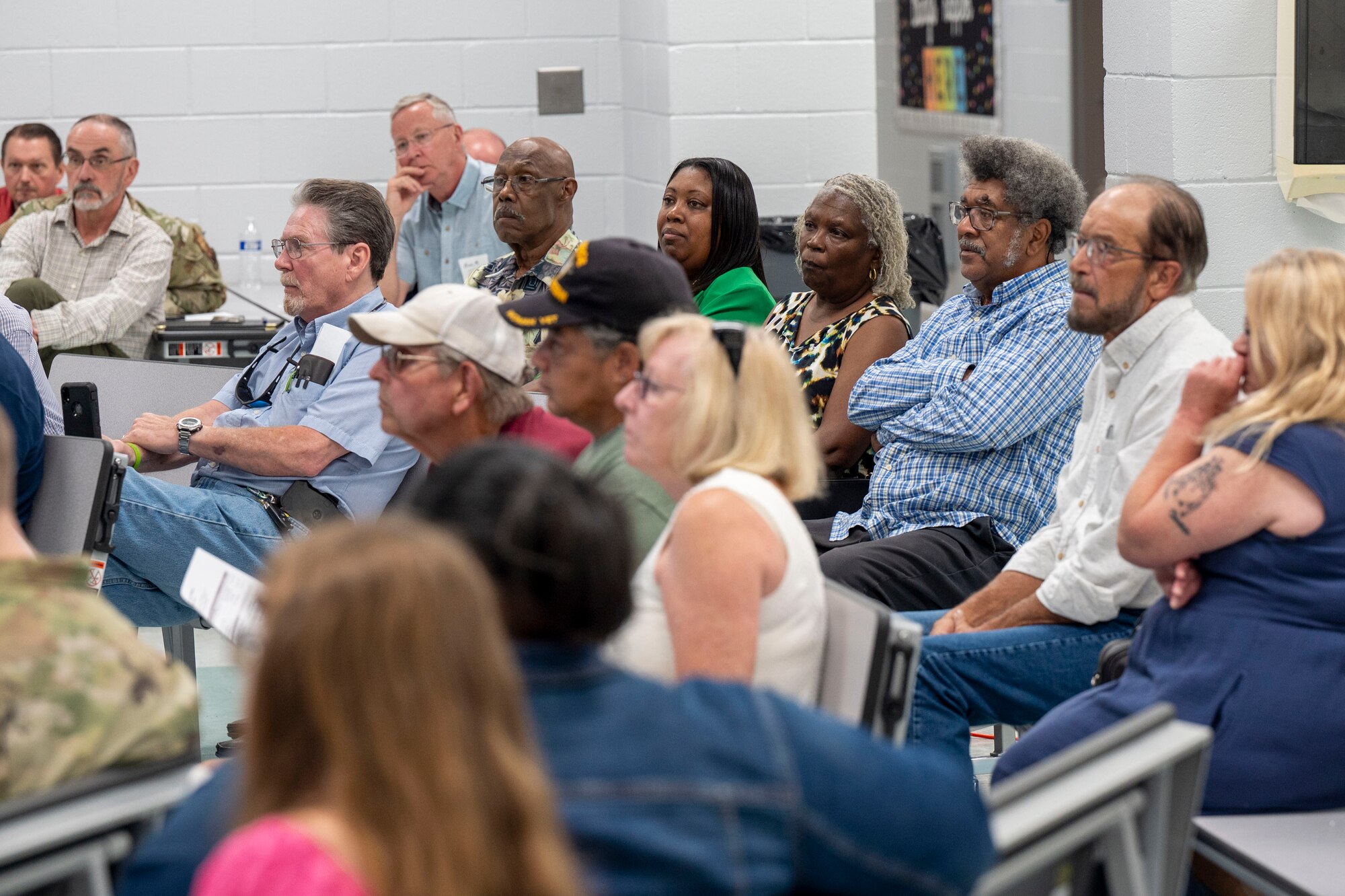 A group shot of community members in the audience.