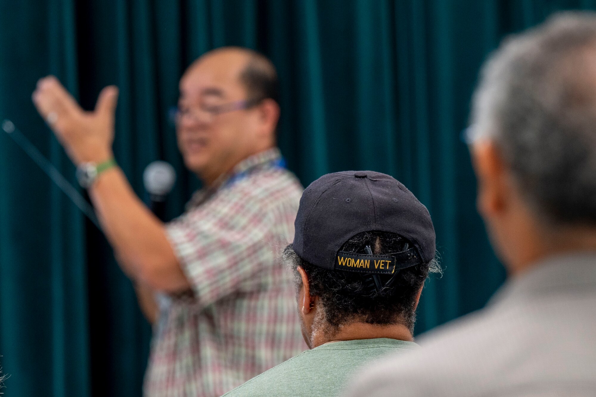 Community members list to someone speak.