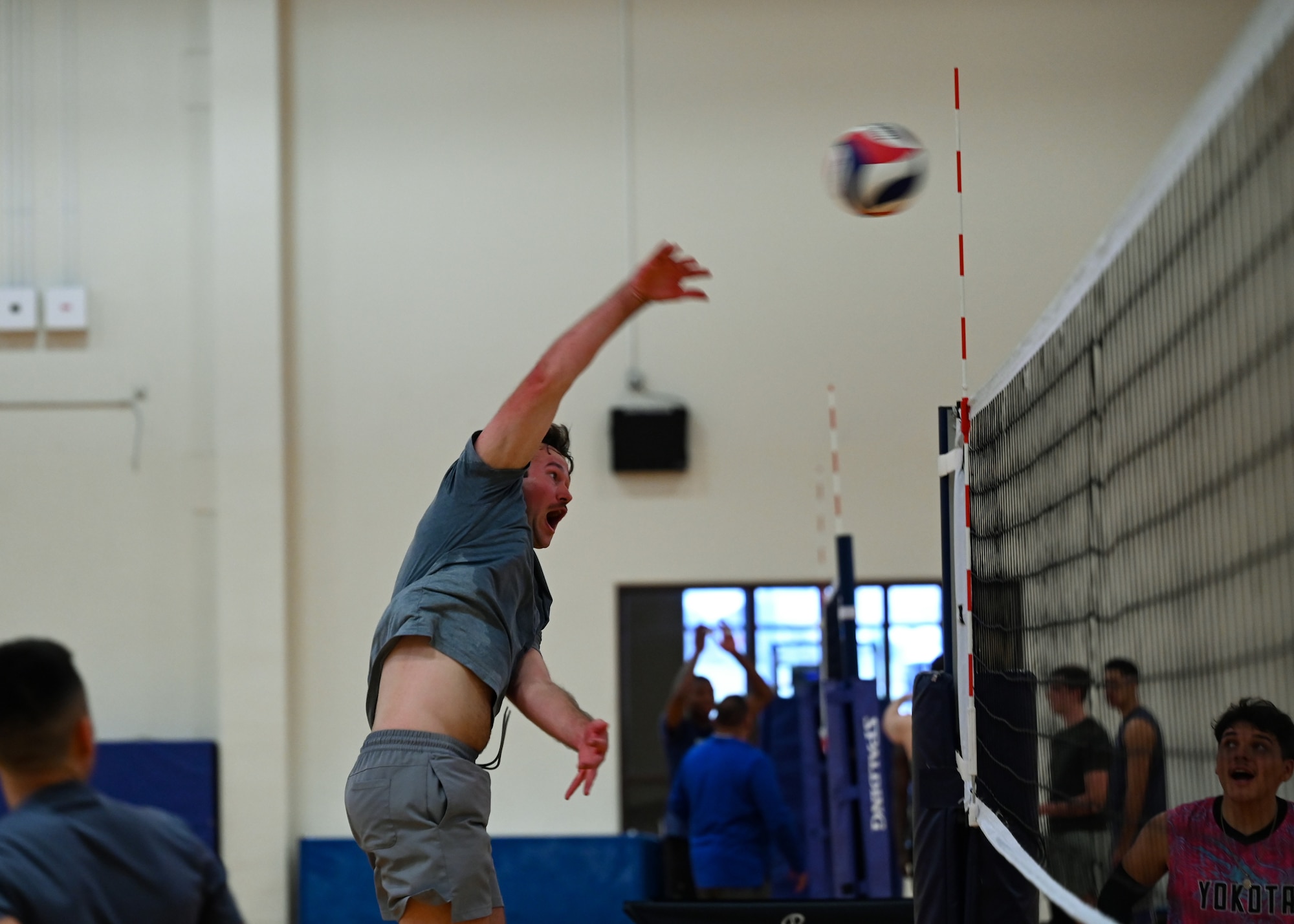 A man spikes a volleyball.