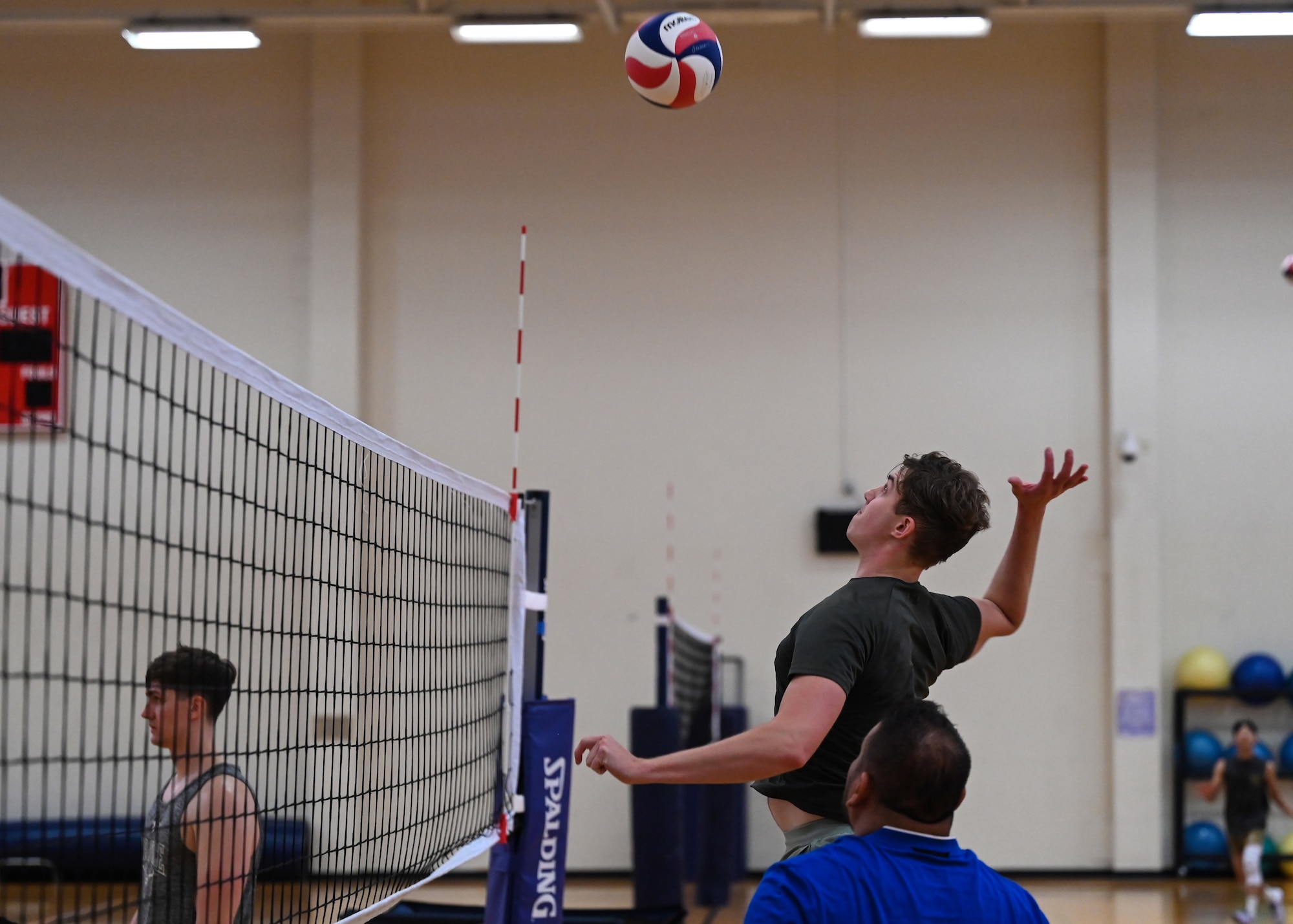 A man prepares to spike a volleyball.