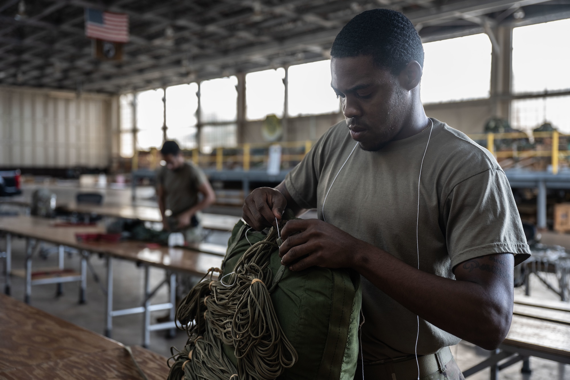 Airman prepares a parachute for future use.