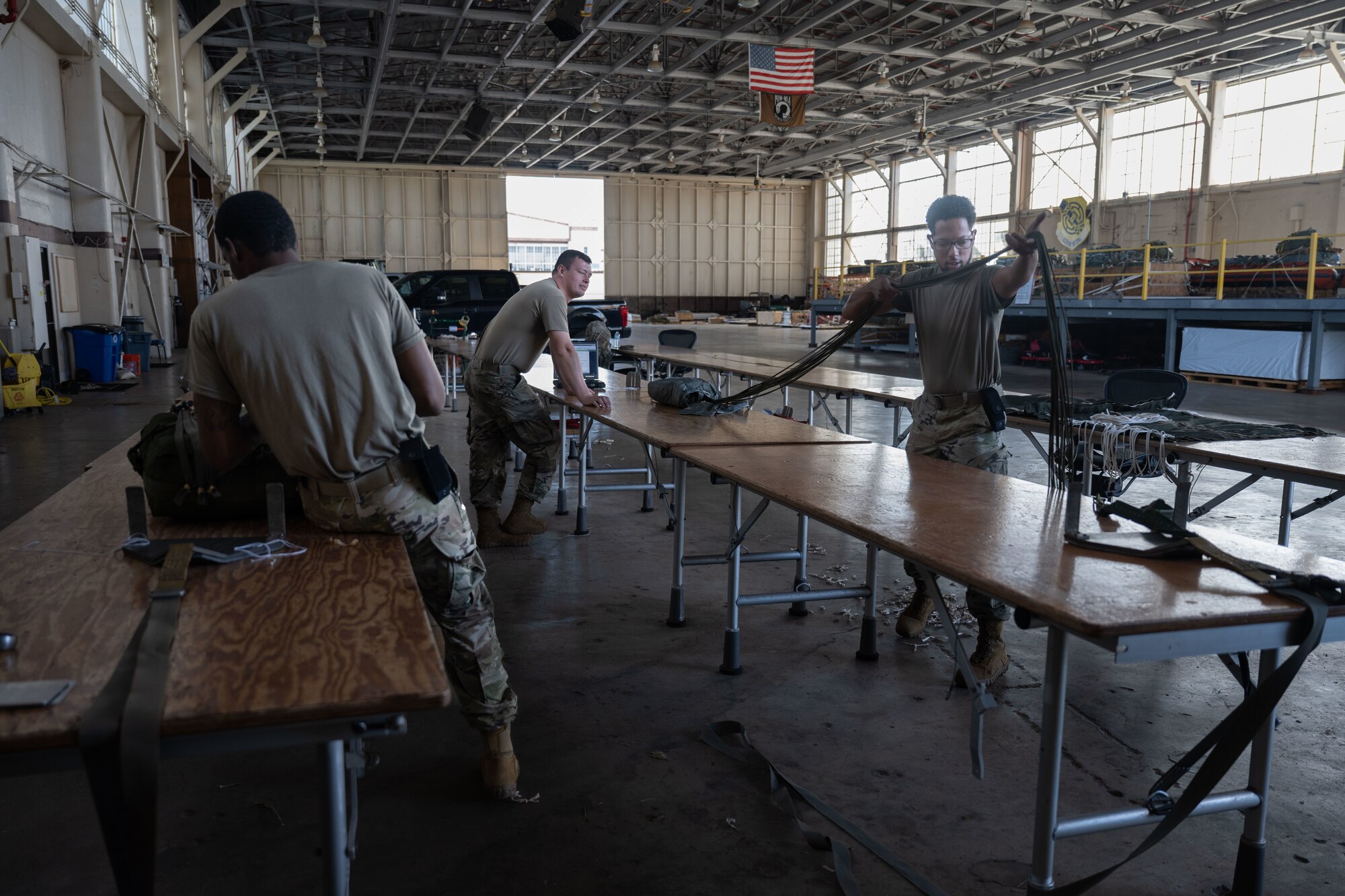 Airmen repair parachutes.